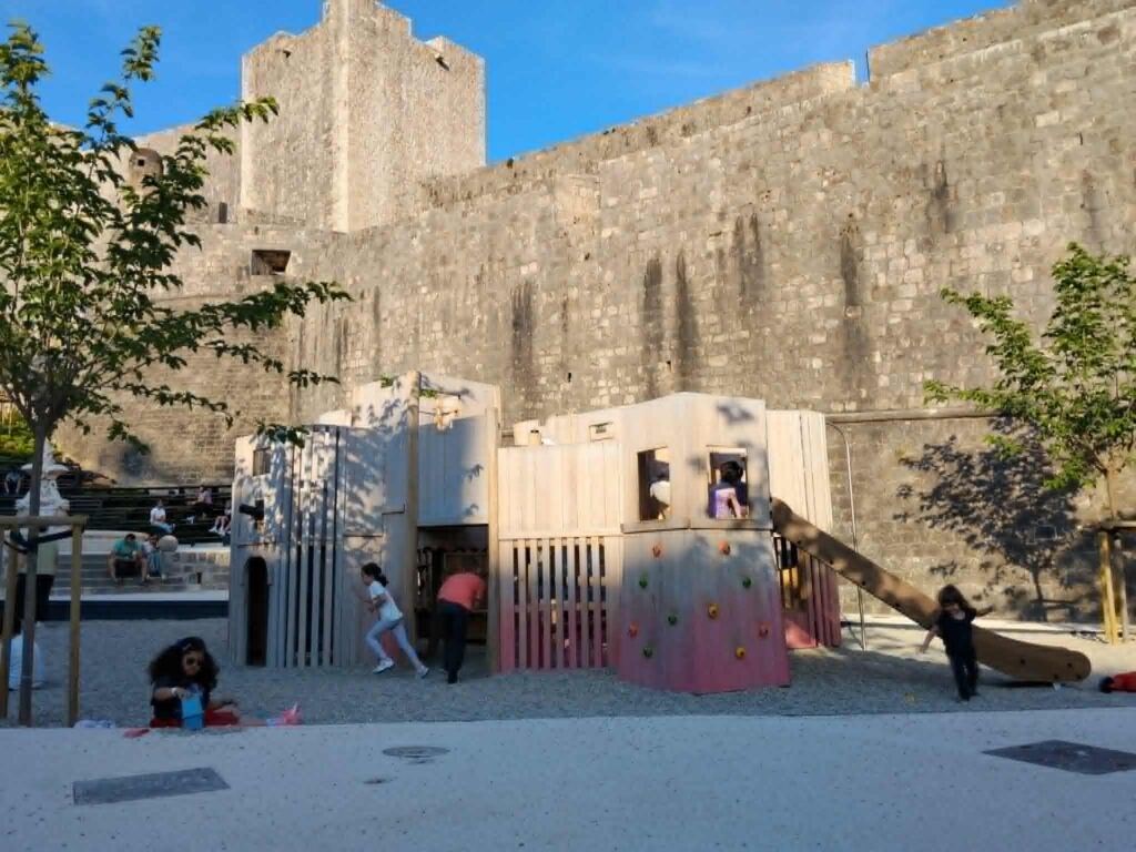 Children playing at Pile Park playground near Dubrovnik Old Town walls